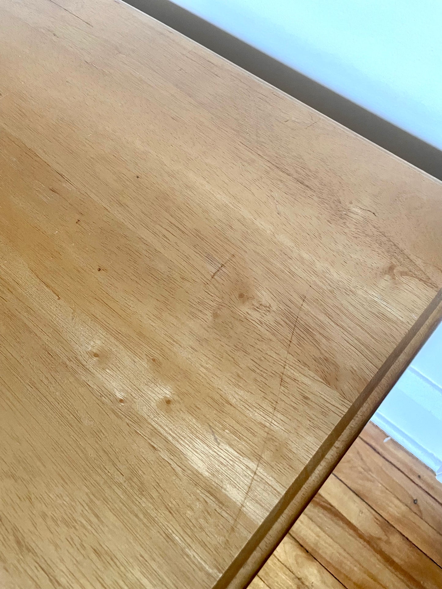 Close-up of a wooden table top with a visible grain pattern