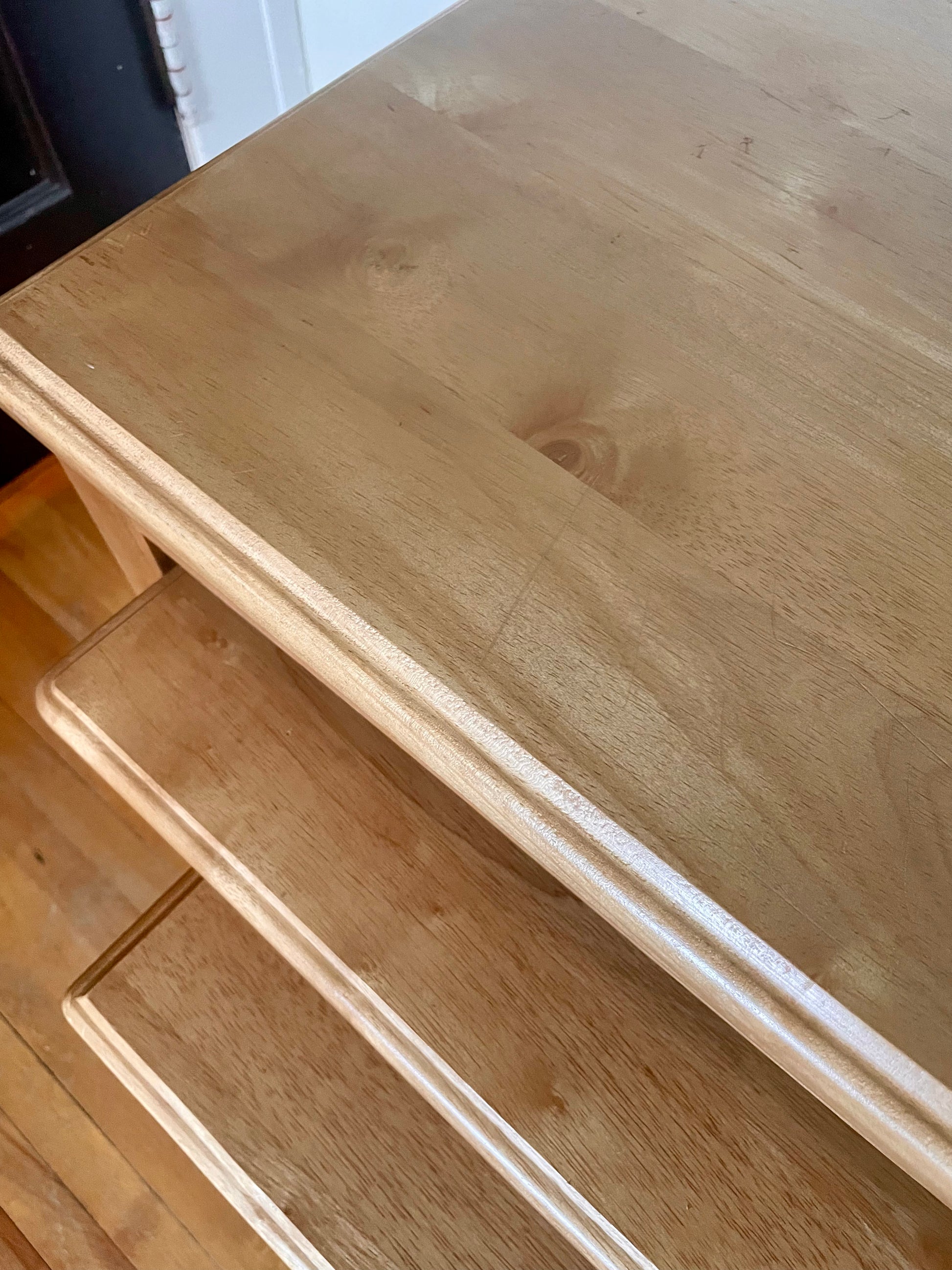 Close-up from above of three wooden nesting tables with a visible grain pattern.